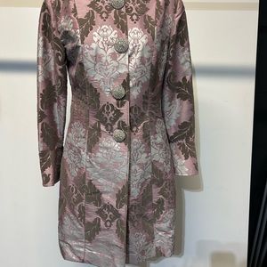 Purple coat embroidered with velvet floral patterns & rhinestone buttons.